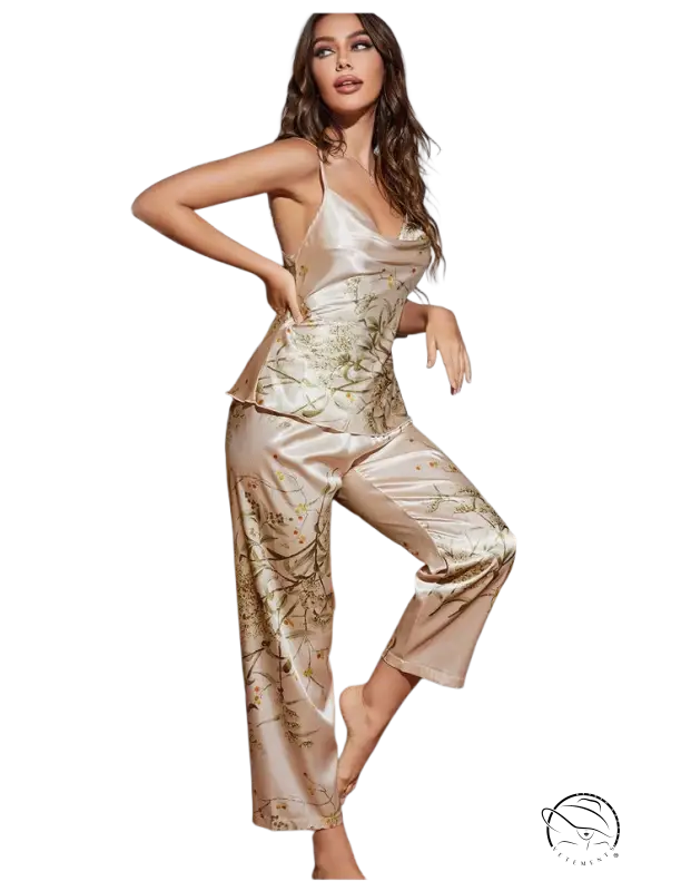 Woman in champagne cherry ice silk pajamas set with floral patterns