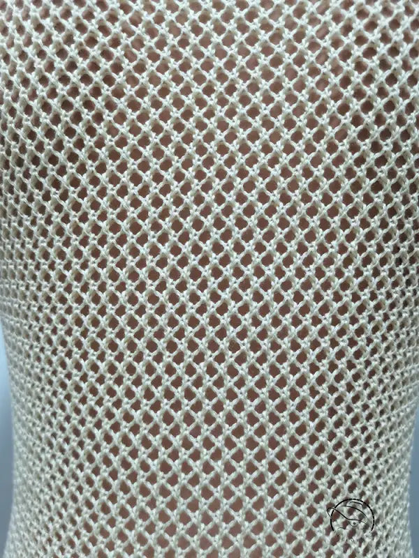 Knitted beach dress in beige crocheted fishnet with fringe detail
