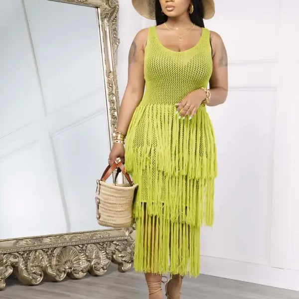 Woman in a light green knitted beach dress with elegant fringe detail