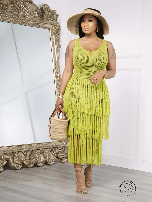 Woman in light green knitted beach dress with elegant fringe detail
