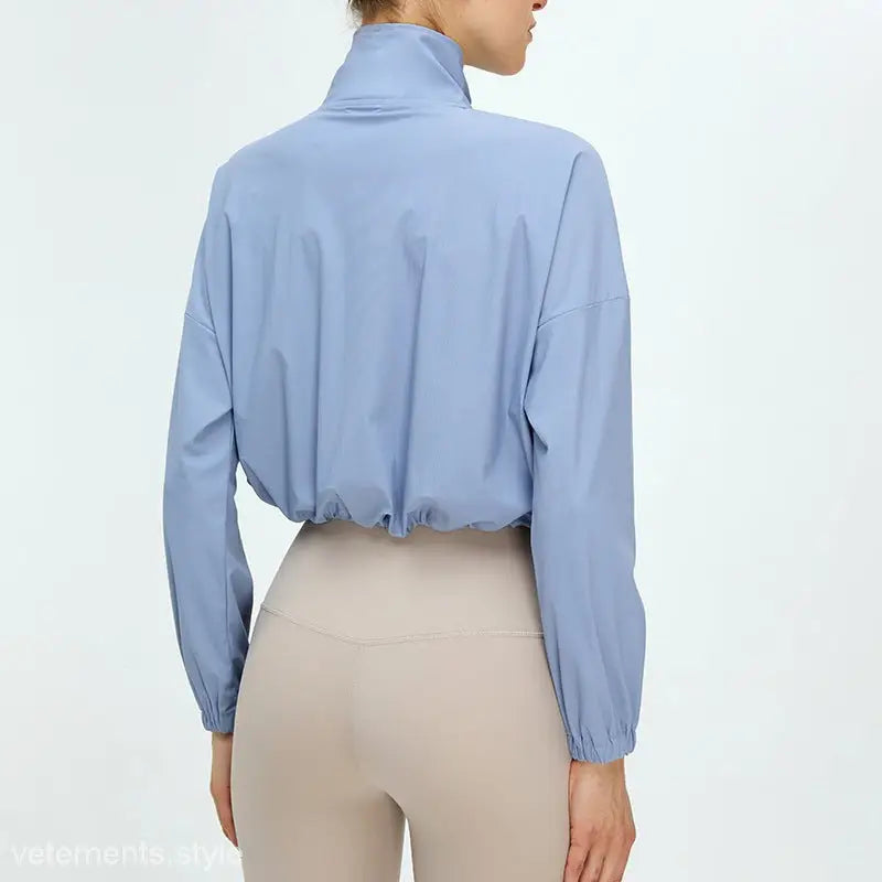 Light khaki and cloudy blue running fitness clothes with a cropped jacket and high collar