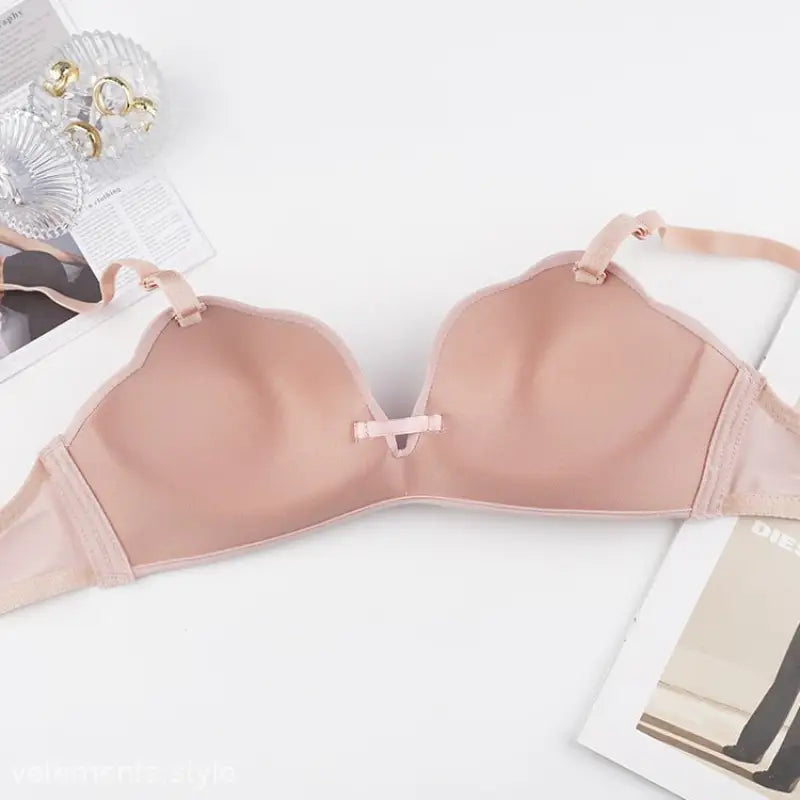 Light pink wireless bra with removable shoulder straps and a small bow detail