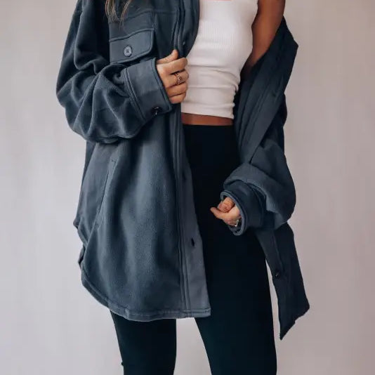 Woman in dark gray oversized Long Sleeve Warm Shacket Coat, white tank, and black leggings