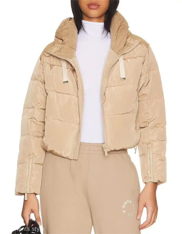 Beige puffer jacket showcasing a loose short cotton jacket with pocket and zipper