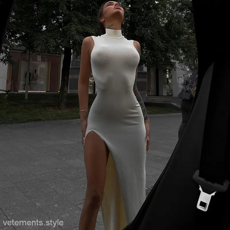 Image of Lyla Party Midi Dress showing a sleeveless slim fit white turtleneck with thigh-high slit