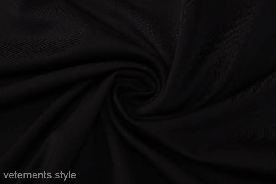 Black fabric with swirling folds in a Metal Chain Halter Maxi Dress for summer events
