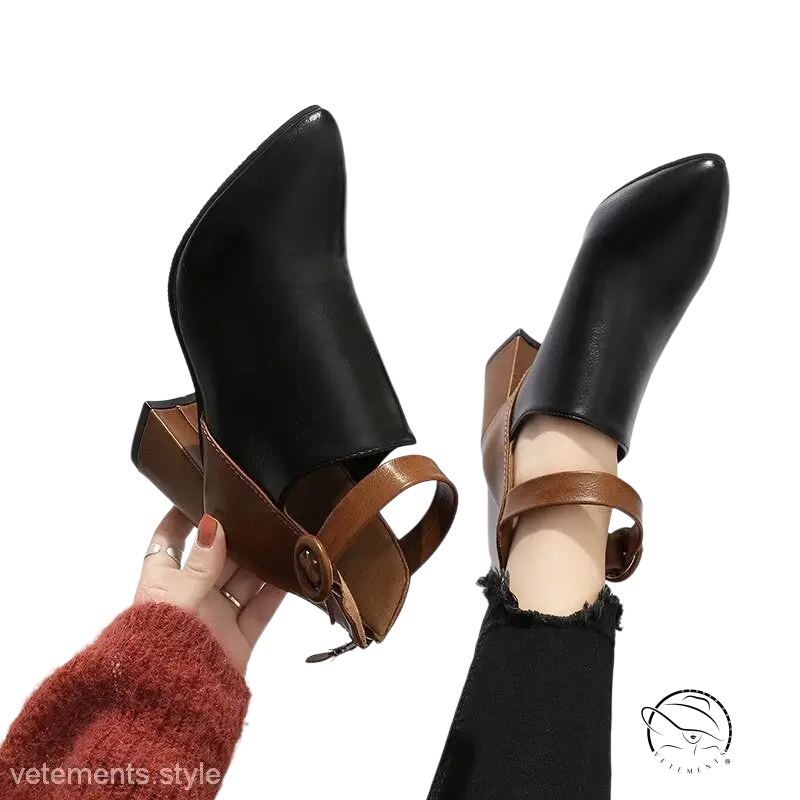 Pair of black high ankle modern booties with brown leather straps and square heel