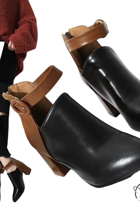 Modern high ankle booties in black leather with tan straps and chunky heels