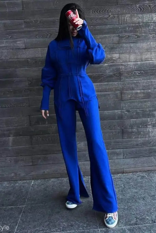 Bright blue full-body jumpsuit with long sleeves and wide legs, part of modern hoodie sets