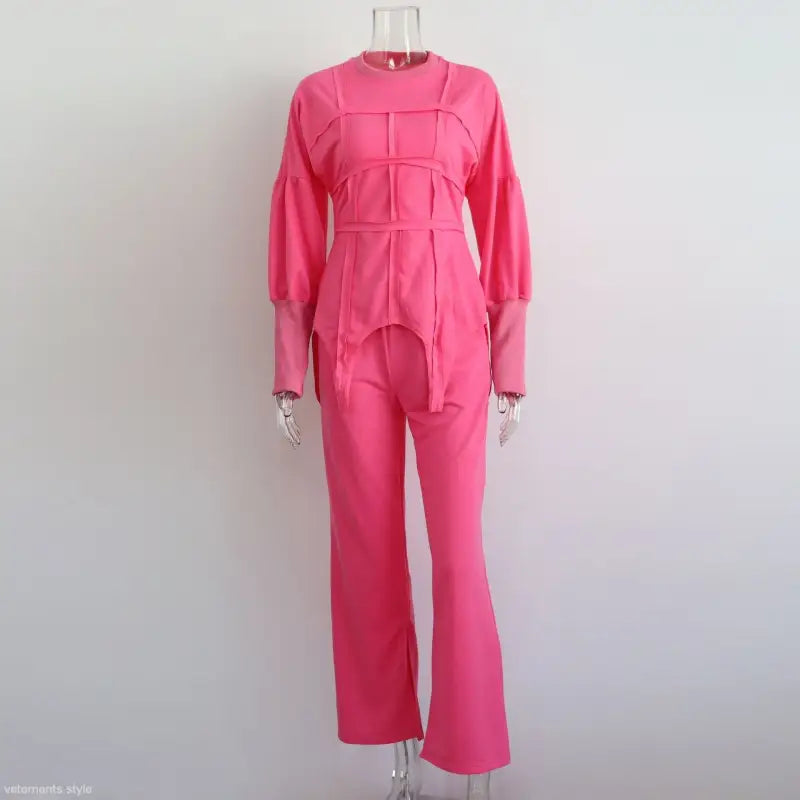 Bright pink jumpsuit with long sleeves and flared pants displayed on a mannequin, ideal for modern hoodie sets and pullover styles