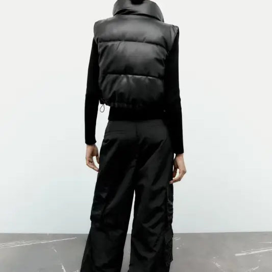 Black puffer vest and wide-leg pants paired with a Modern Short Faux Leather Jacket for winter