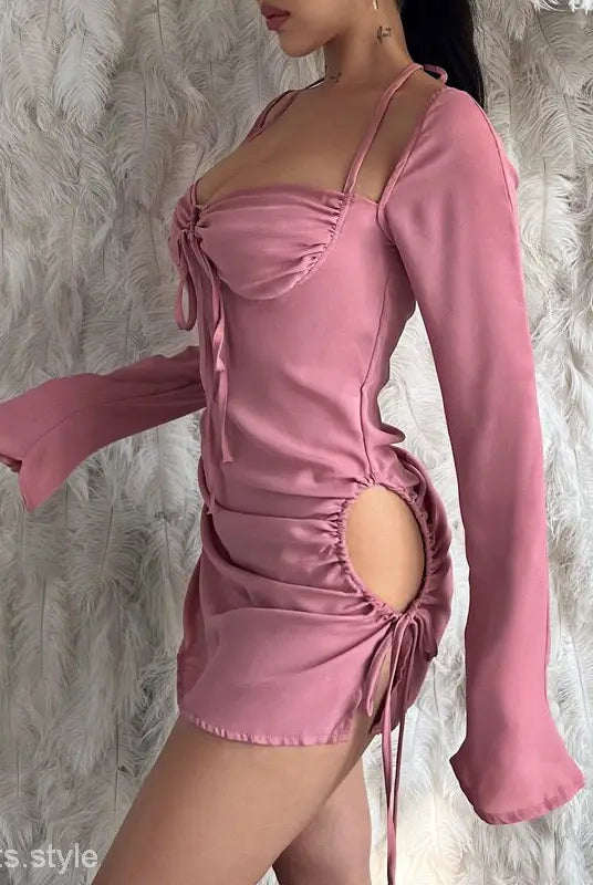 Pink long-sleeved mini dress with ruched details, perfect for spring and summer parties