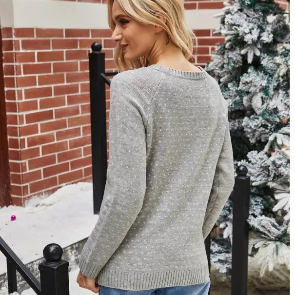 Woman wearing a navy blue Christmas snowflake sweater for casual fall winter wear