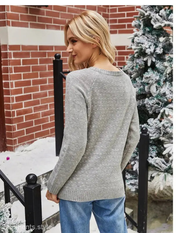 Woman wearing a navy blue Christmas snowflake sweater for casual fall winter wear
