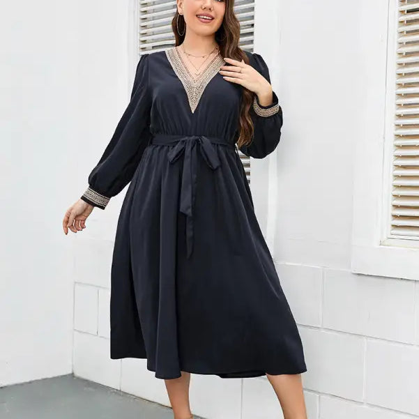 Navy blue midi dress with a V-neck, long sleeves, and a tie waist.