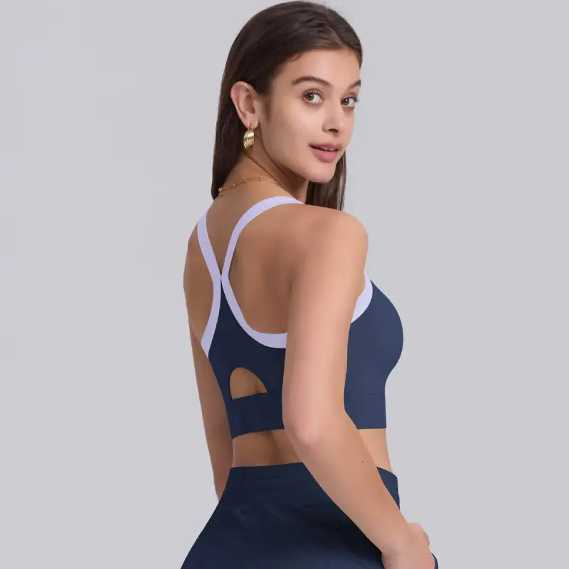 Navy blue strength yoga bra with lavender trim, ideal for high strength yoga workouts