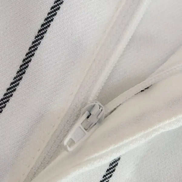 White suit with black striped fabric and a white zipper, ideal for office style slim look