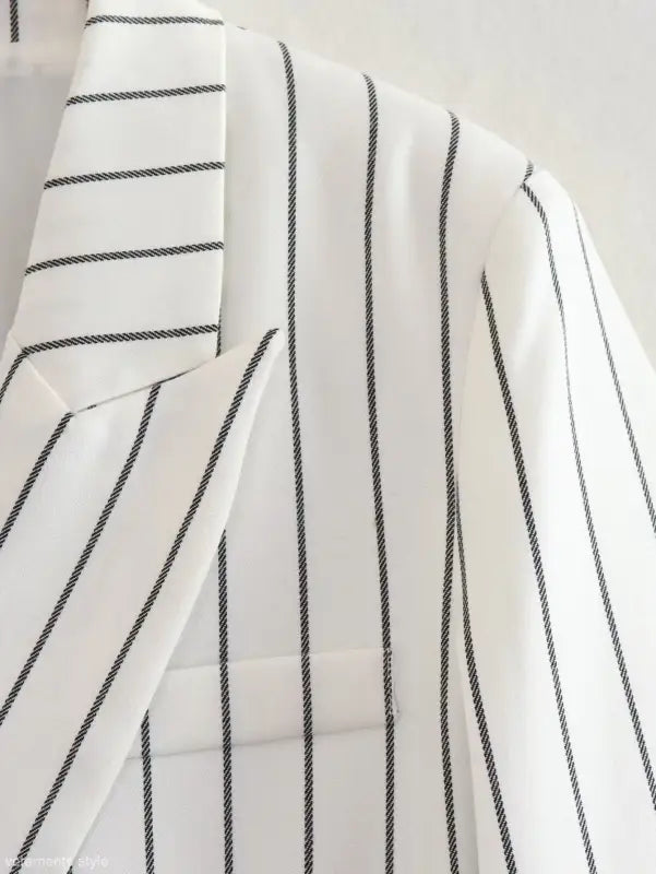 White fabric with thin black vertical stripes for office style slim white suit with gray trousers