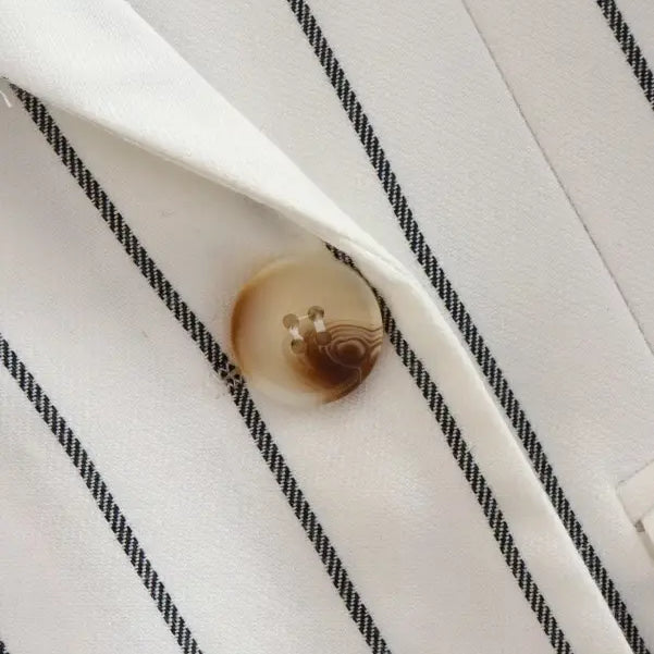 Button on white fabric with thin black stripes from Office Style Slim White Suit with Gray Trousers