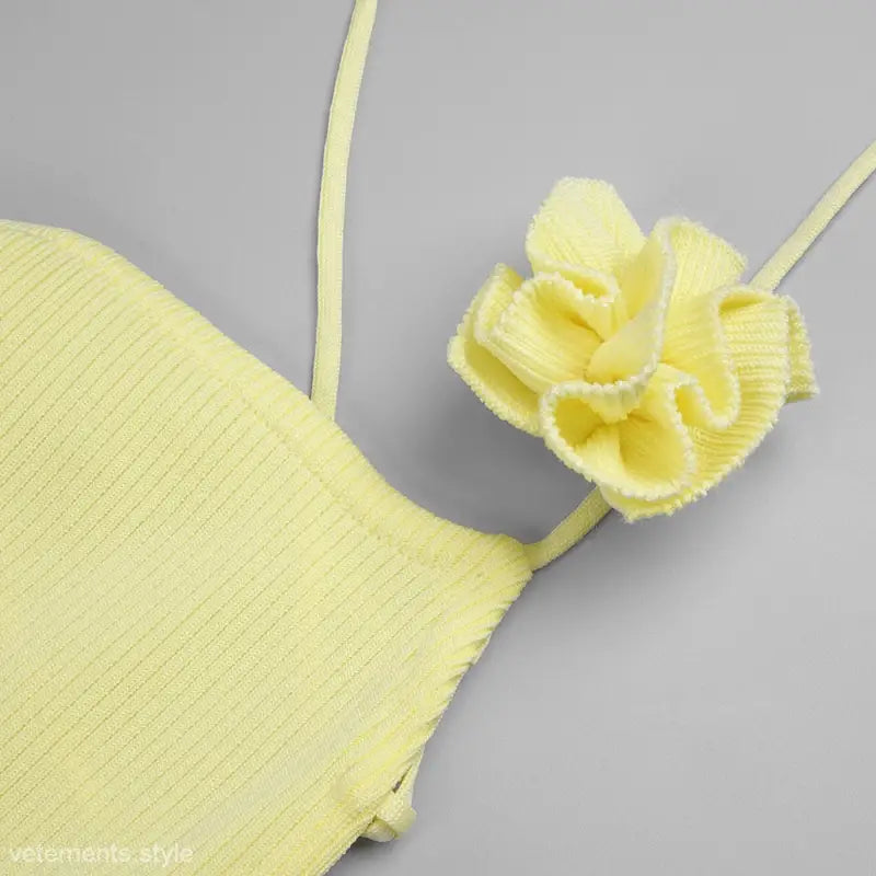 Pale yellow ribbed halter-neck top with ruffled flower detail, perfect for yellow sold fashion