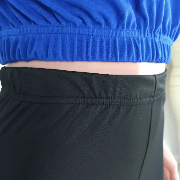 Midsection of person wearing blue top and black bottoms from casual hoodie two piece set