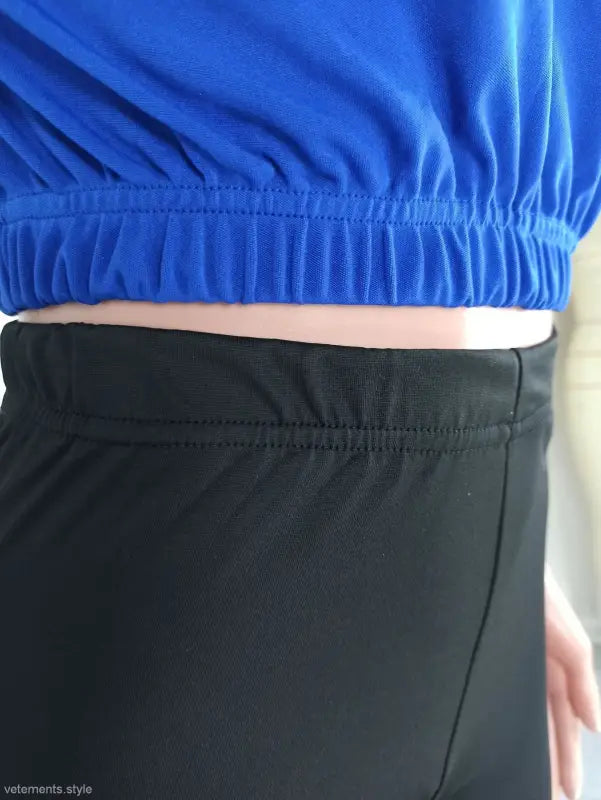 Midsection of person wearing blue top and black bottoms from casual hoodie two piece set