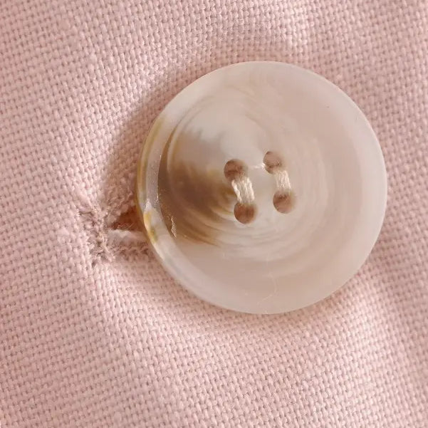 Round four-hole pink button displayed on Pink Pants and Top Blazer High in linen blend short style