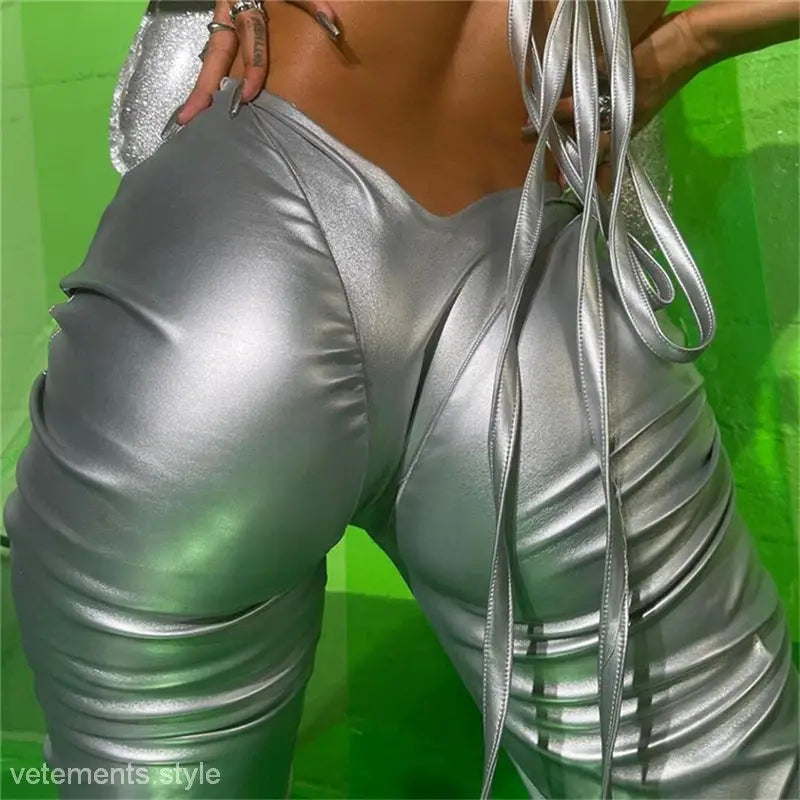 Shiny silver poly urethane leather bodysuit with ruched detailing, sexy low waist design