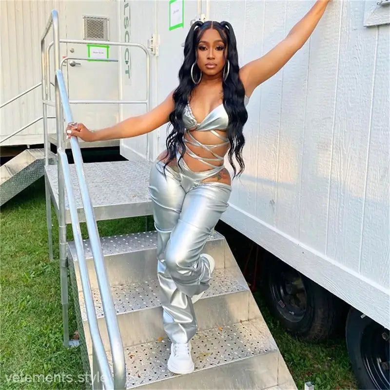 Woman in shiny poly urethane leather outfit posing on trailer steps showcasing sexy low waist style