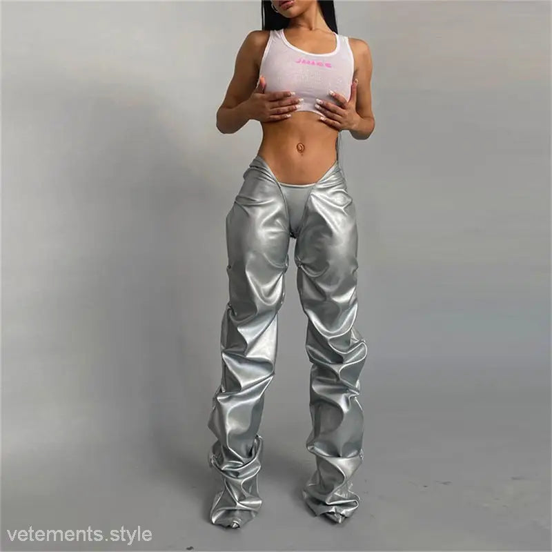 Woman in white crop top and shiny poly urethane leather pants showcasing sexy low waist style