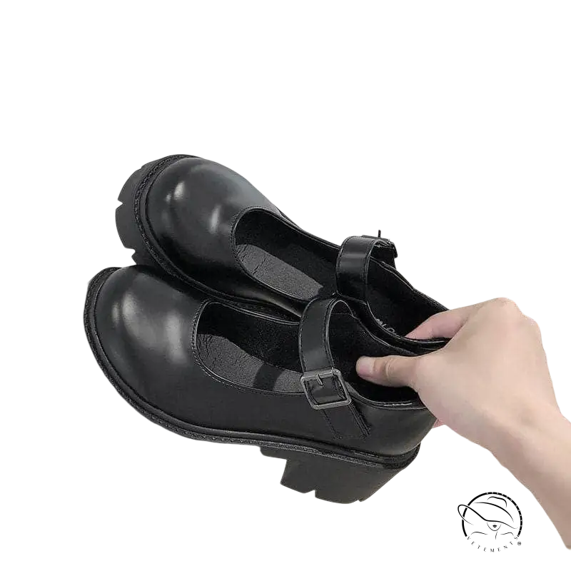 Buckle platform heels in matte black patent leather with chunky textured sole