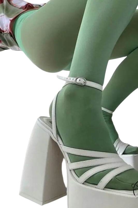 Elegant ankle strap heel with white platforms, strappy details, and mint green tights