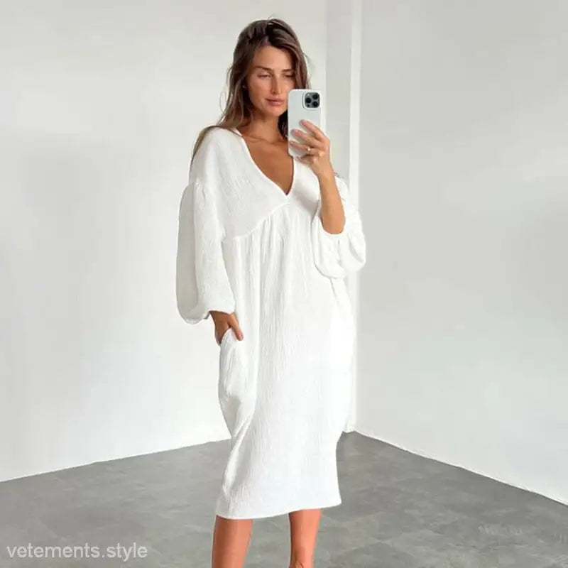 White flowy midi dress with V-neck and billowy sleeves, perfect as pure cotton confinement pajamas