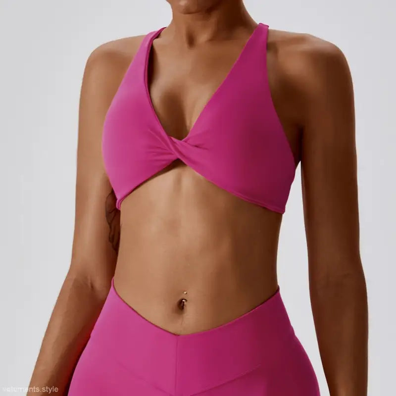 Pink twisted-front sports bra in dark reddish purple and tropical orange for quick drying yoga workouts