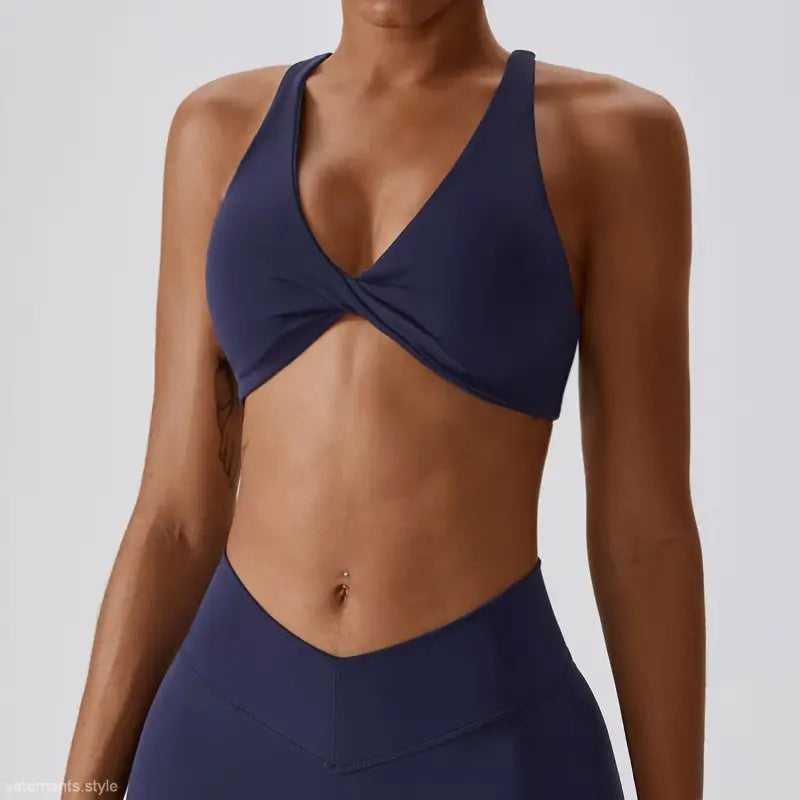 Navy blue twisted sports bra for quick drying yoga in dark reddish purple and tropical orange
