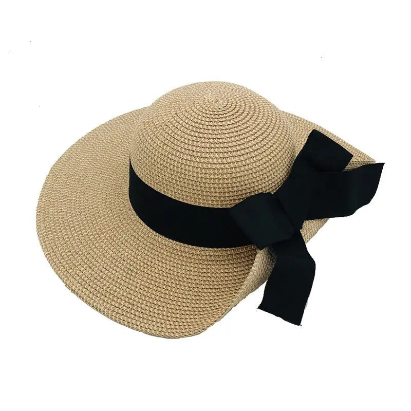 Tan straw sunhat with black ribbon featured in the Raffia Bucket Hat with Big Bow Sunshade