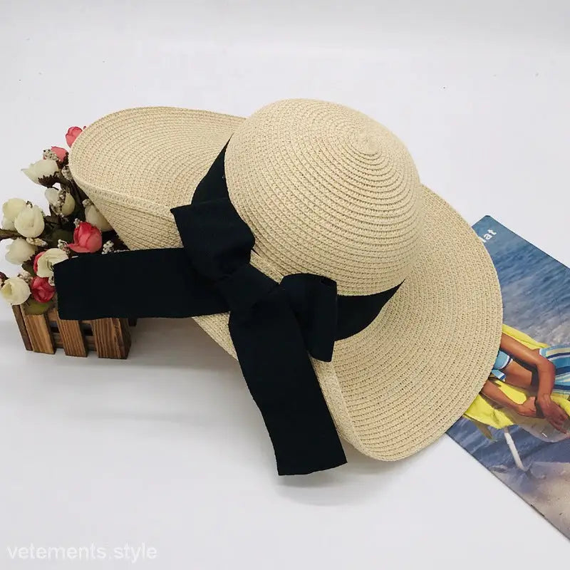 Straw sun hat with black ribbon, showcasing a regular big bow sunshade for elegance