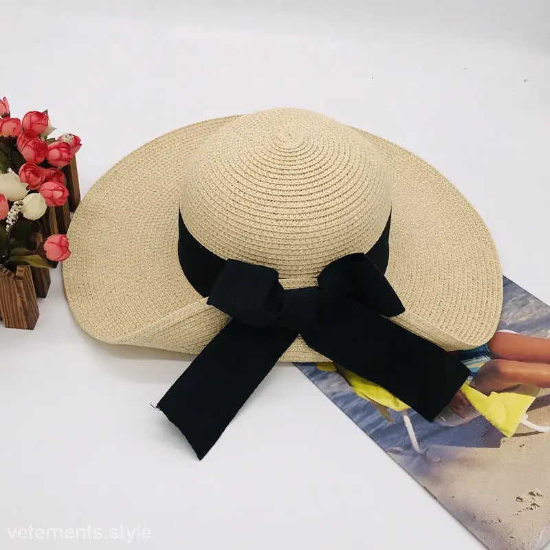 Beige straw sunhat with black ribbon, a chic big bow sunshade for natural elegance