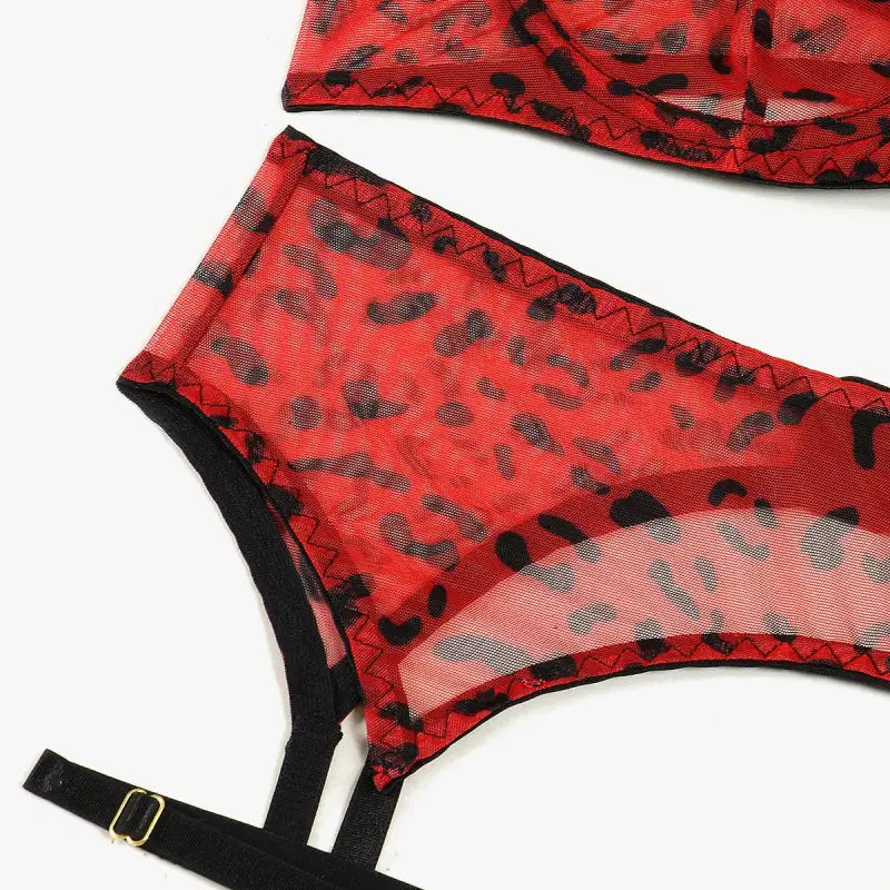 Red leopard print three-piece lace and fishnet lingerie set with black trim and adjustable straps