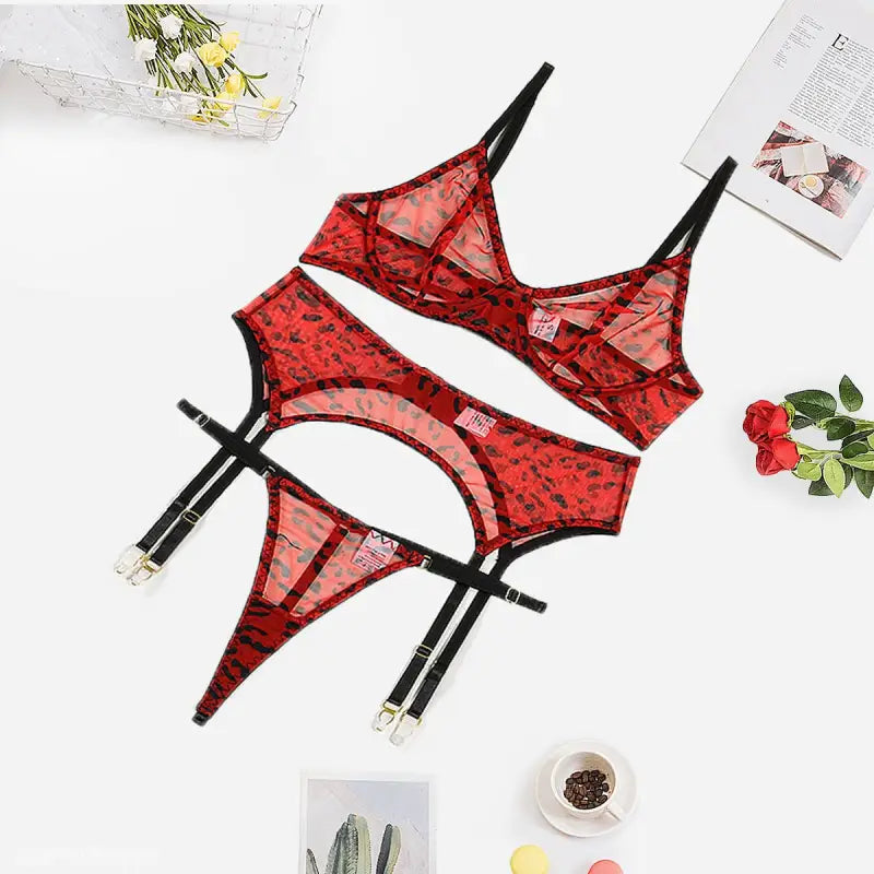 Red leopard print three-piece lace and fishnet lingerie set with bra, panties, and garter belt