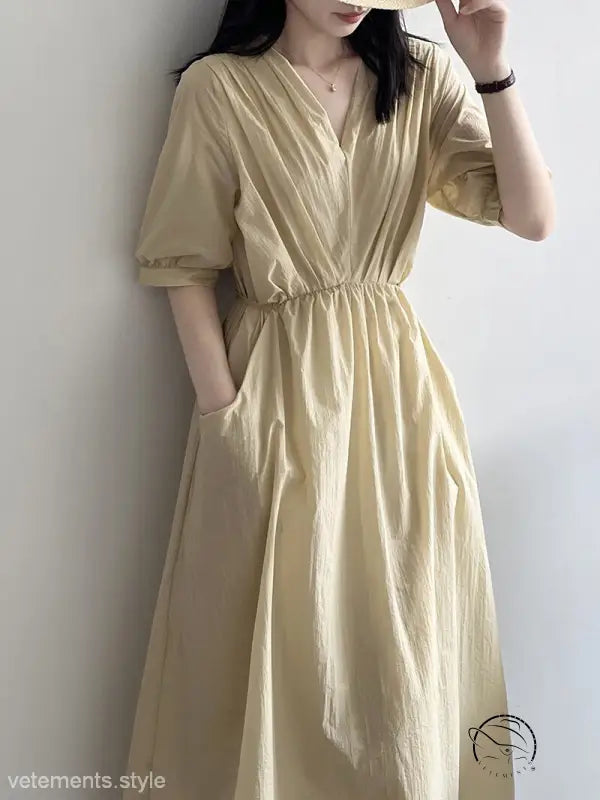 Retro v neck pleated midi dress in pale yellow with cinched waist