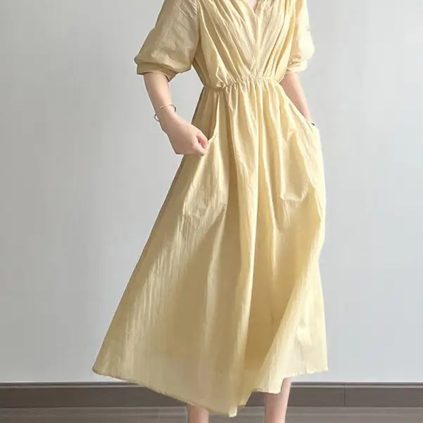 Pale yellow Retro V Neck pleated dress featuring puffed sleeves and cinched waist