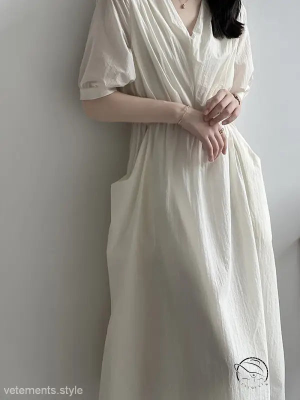 Retro v neck pleated midi dress in white flowy fabric with short sleeves and gathered waist