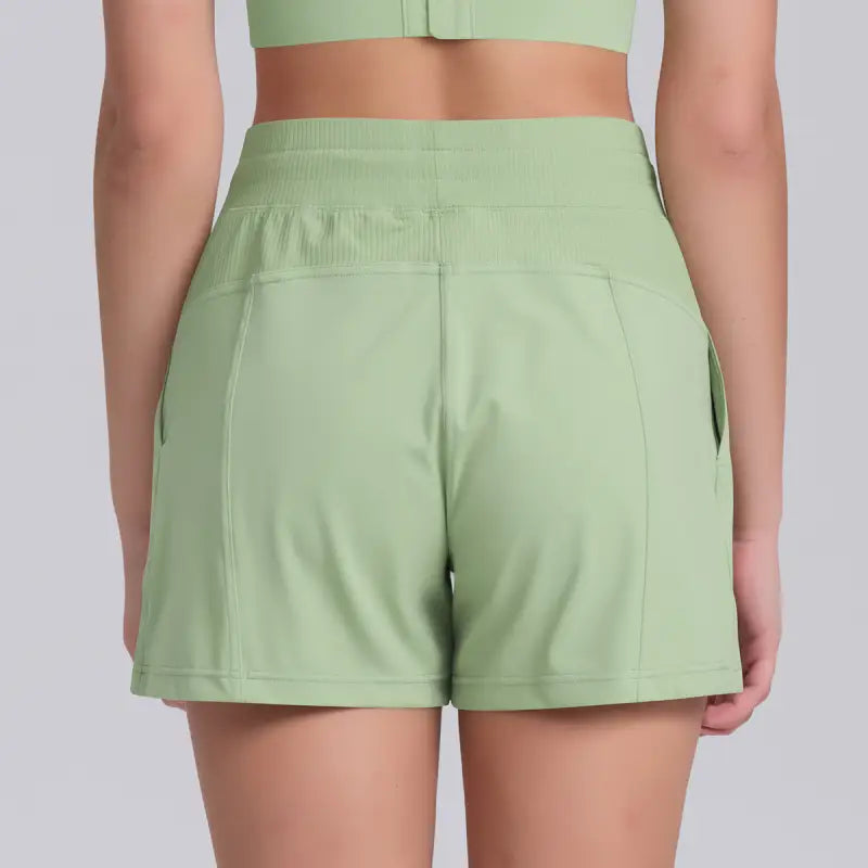 Light green casual yoga shorts with solid pocket design for comfortable athletic wear