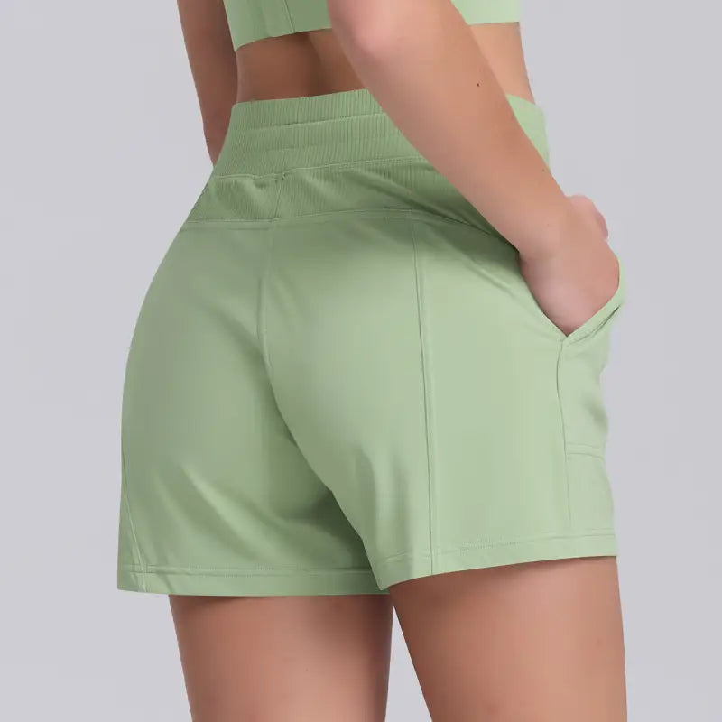 Light green casual yoga shorts with solid pocket design for comfortable workouts