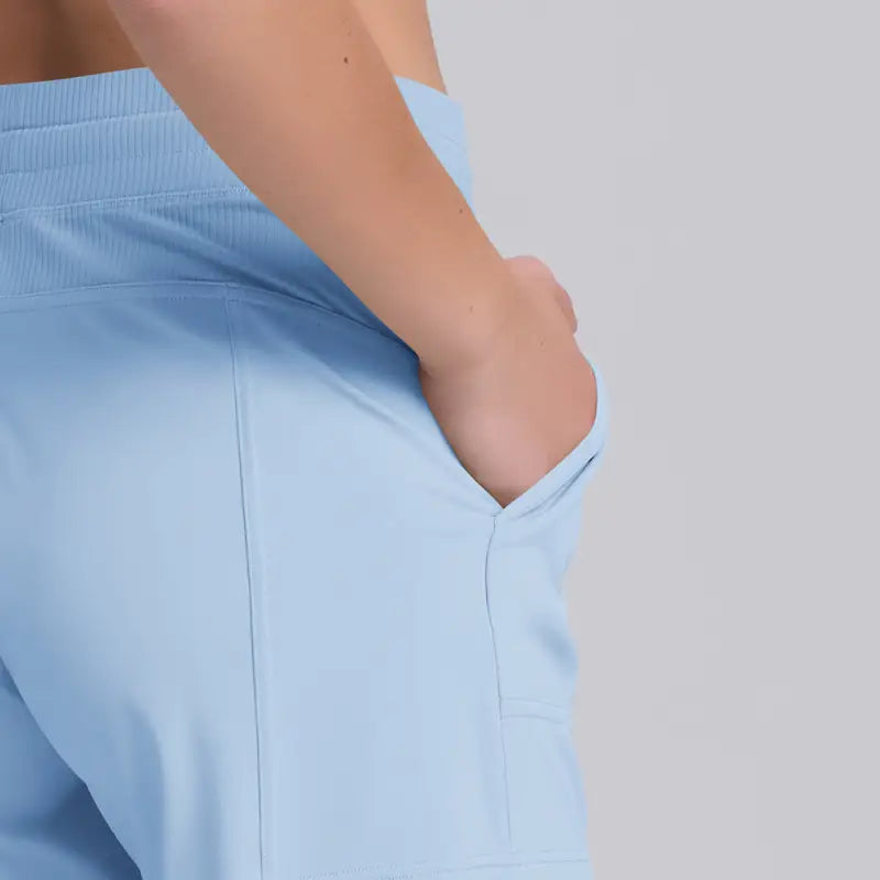 Light blue casual yoga shorts with rose pink pocket design and hand in pocket