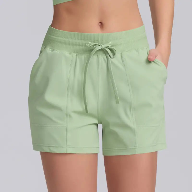 Light green casual yoga shorts with solid pocket design for comfortable workout wear