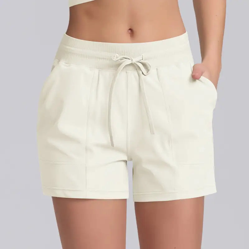 Cream-colored drawstring casual yoga shorts with rose pink design and solid pocket style