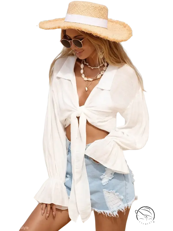 Woman in royal blue boho tie sleeve top on beach vacation