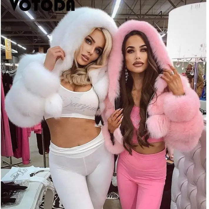 Two women in royal blue faux fur coat with silver fox hood and activewear